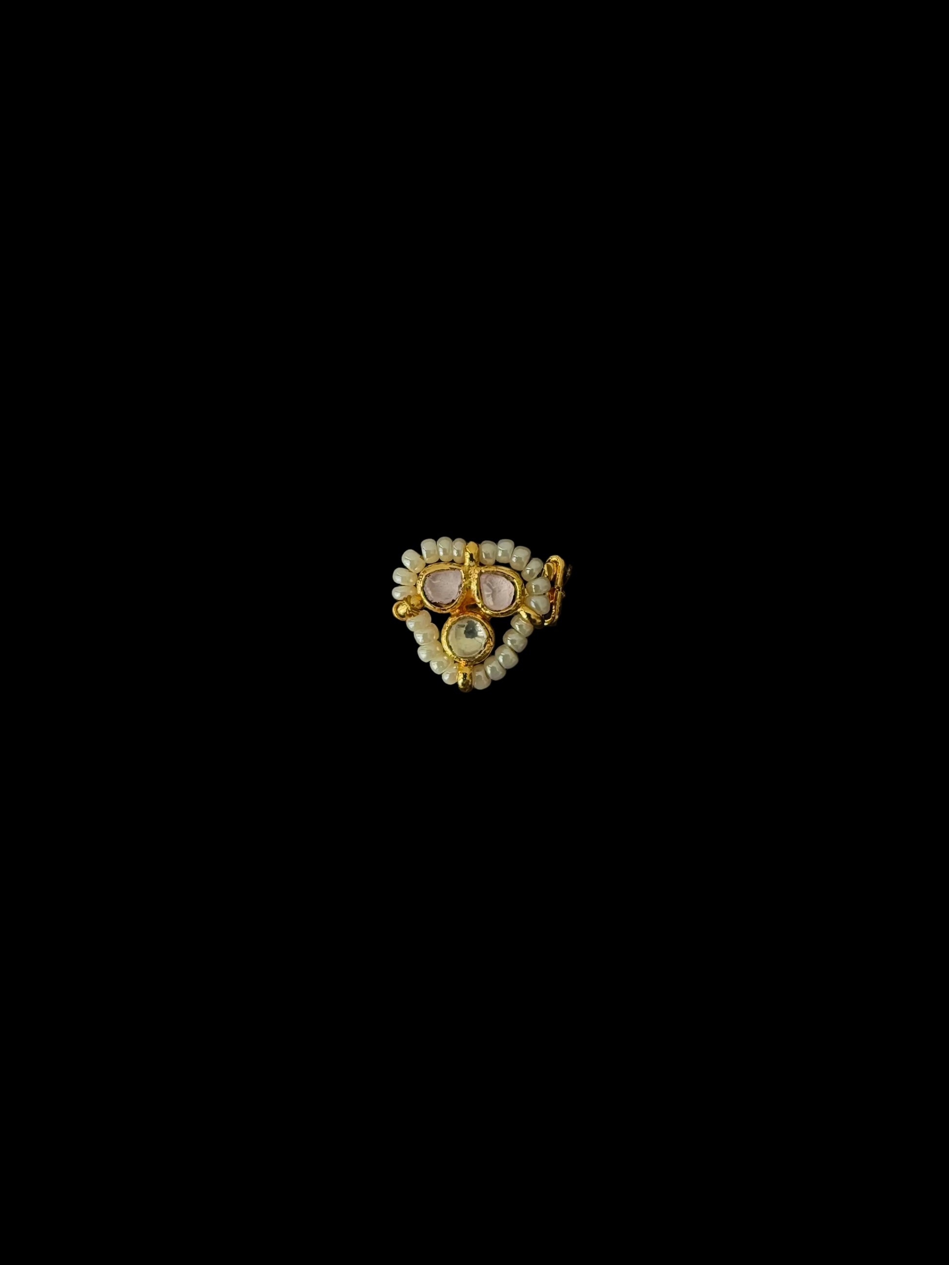 Gold and diamond brooch on a black background