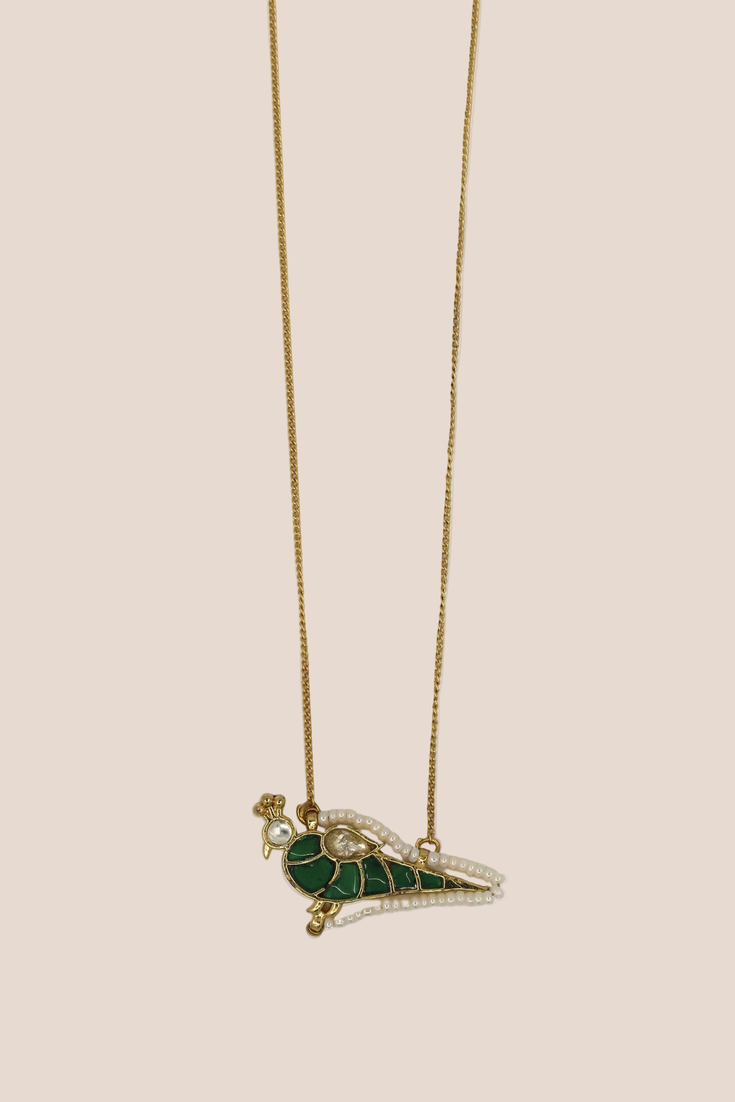 Necklace with a green and gold pendant on a white background