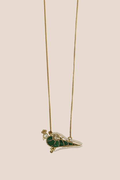 Necklace with a green and gold pendant on a white background