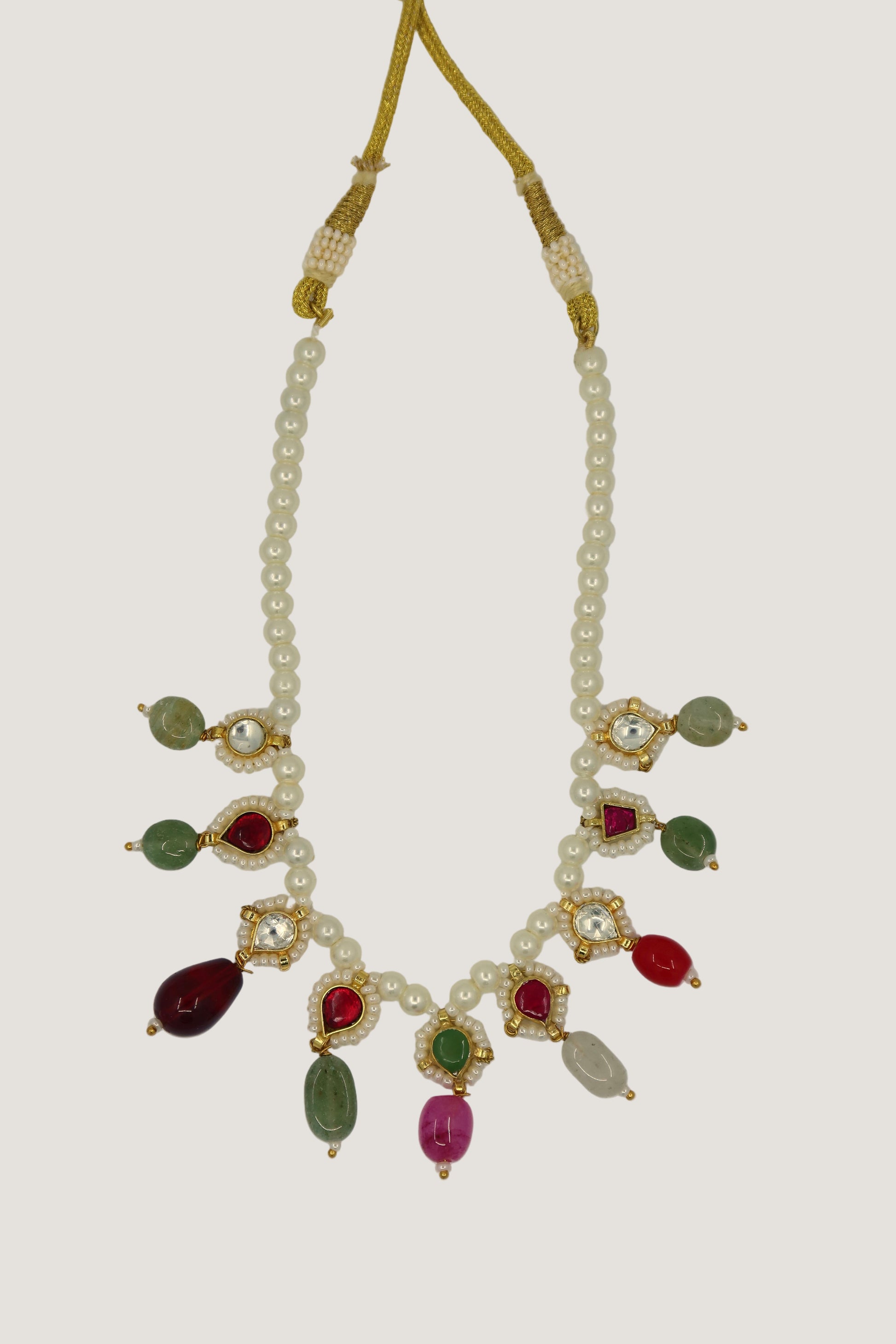 Necklace with pearls and gemstones on a white background