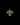 Gold and green brooch on a black background